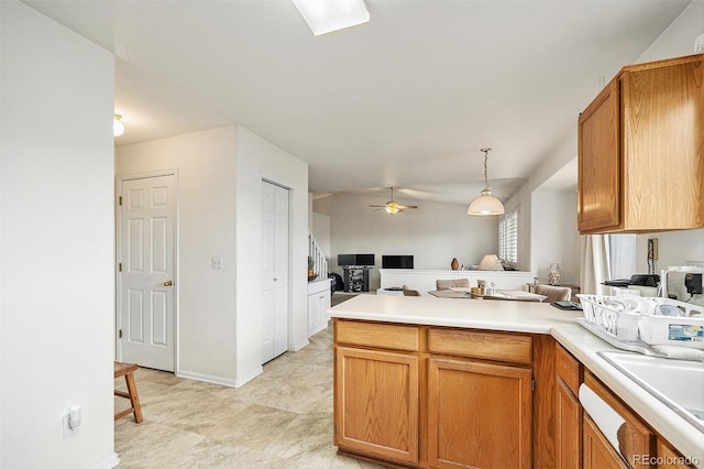 4710 N Foxtail Dr, Castle Rock, CO 80109 - kitchen with open floor plan, a peninsula, ceiling fan, light countertops, and pendant lighting