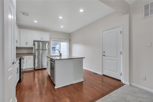 3678 Shadow Cir, Castle Rock, CO 80109 - kitchen with stainless steel appliances, white cabinetry, a center island with sink, light stone counters, and recessed lighting