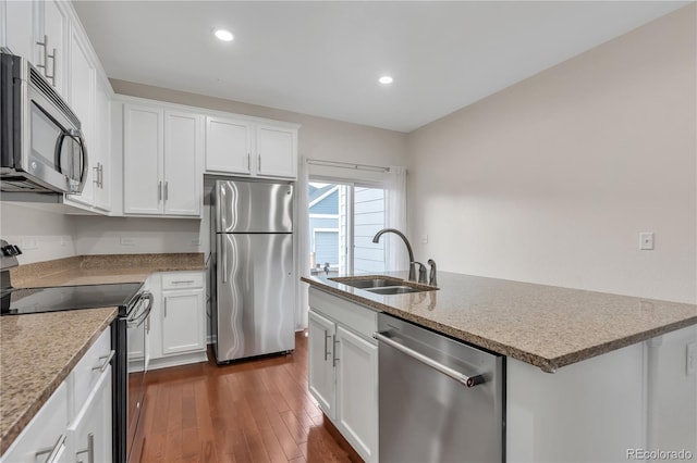 3678 Shadow Cir, Castle Rock, CO 80109 - kitchen with stainless steel appliances, dark wood-style flooring, white cabinetry, an island with sink, and recessed lighting