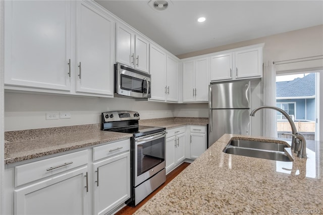3678 Shadow Cir, Castle Rock, CO 80109 - kitchen featuring stainless steel appliances, white cabinets, light stone countertops, and recessed lighting