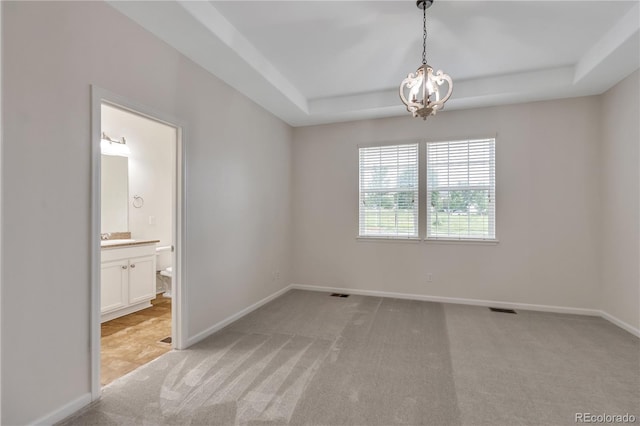3678 Shadow Cir, Castle Rock, CO 80109 - empty room featuring light colored carpet, a tray ceiling, and a chandelier