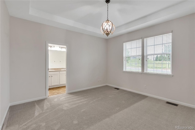 3678 Shadow Cir, Castle Rock, CO 80109 - empty room with light carpet, a raised ceiling, and a chandelier