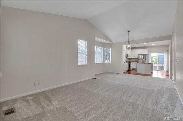3678 Shadow Cir, Castle Rock, CO 80109 - unfurnished living room with light carpet, lofted ceiling, and a chandelier
