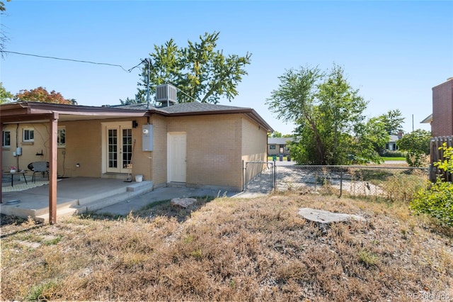 back of house featuring cooling unit and a patio