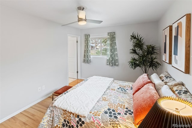 bedroom with hardwood / wood-style floors and ceiling fan