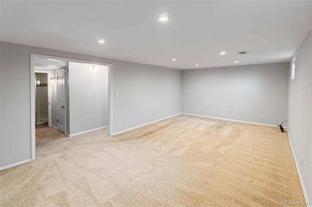 unfurnished room with light colored carpet