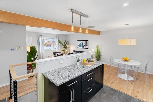 kitchen featuring dark hardwood / wood-style floors, a kitchen island, and hanging light fixtures