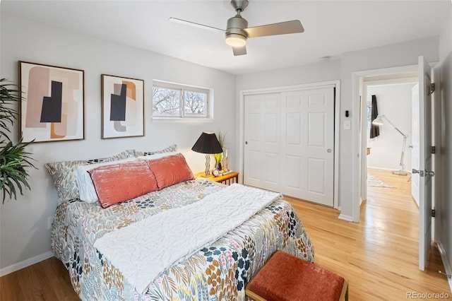 bedroom with hardwood / wood-style floors, a closet, and ceiling fan