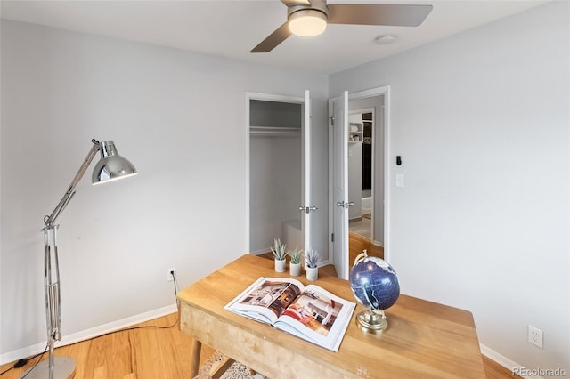 home office featuring hardwood / wood-style flooring and ceiling fan