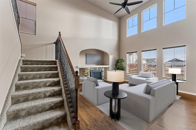 living room with hardwood / wood-style flooring and a towering ceiling