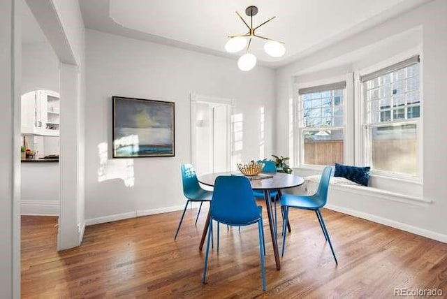 dining space featuring a notable chandelier and hardwood / wood-style flooring