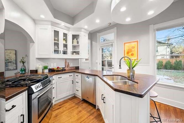 kitchen featuring a healthy amount of sunlight, sink, white cabinets, and stainless steel appliances