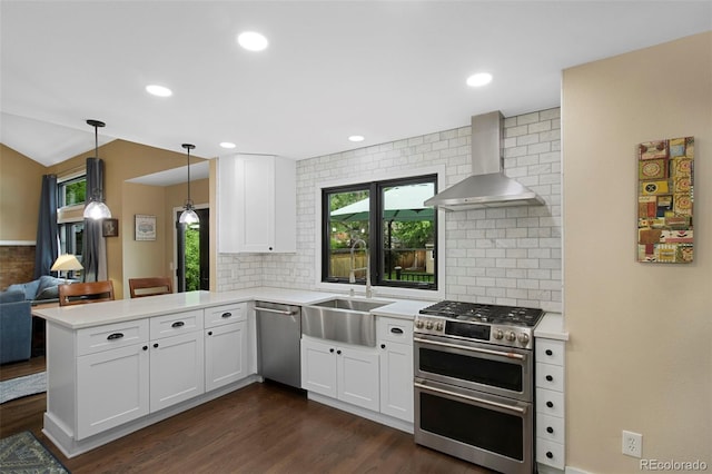 23 Honey Locust, Littleton, CO 80127 - kitchen with stainless steel appliances, wall chimney exhaust hood, tasteful backsplash, light countertops, and plenty of natural light