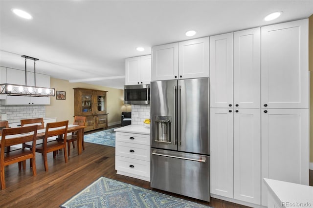 23 Honey Locust, Littleton, CO 80127 - kitchen featuring stainless steel appliances, backsplash, light countertops, white cabinets, and recessed lighting