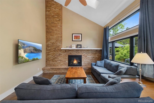 23 Honey Locust, Littleton, CO 80127 - living area featuring high vaulted ceiling, wood finished floors, a brick fireplace, ceiling fan, and a skylight