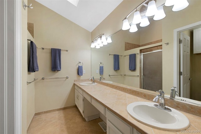 23 Honey Locust, Littleton, CO 80127 - bathroom featuring a stall shower, double vanity, lofted ceiling, and tile patterned floors