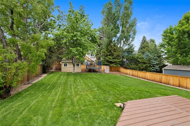 23 Honey Locust, Littleton, CO 80127 - fenced backyard featuring a shed and a deck