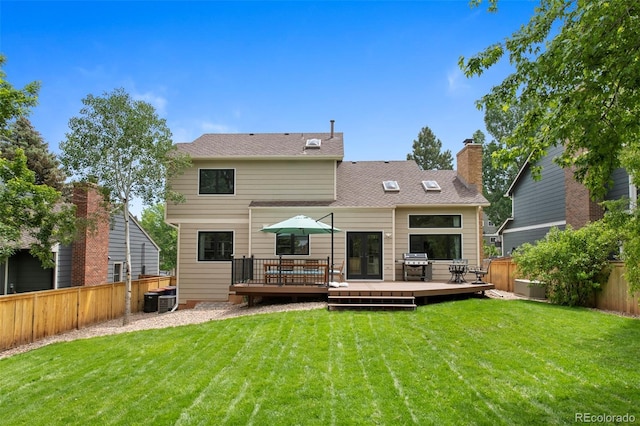 23 Honey Locust, Littleton, CO 80127 - rear view of property featuring a fenced backyard, a deck, and a chimney