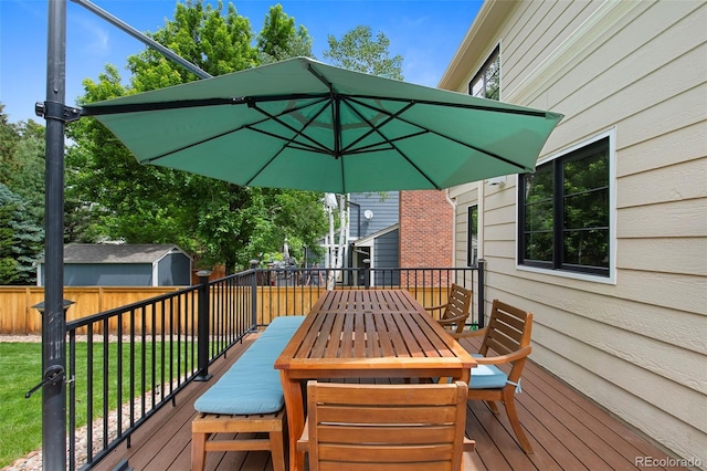23 Honey Locust, Littleton, CO 80127 - deck featuring a fenced backyard, outdoor dining area, and a storage unit