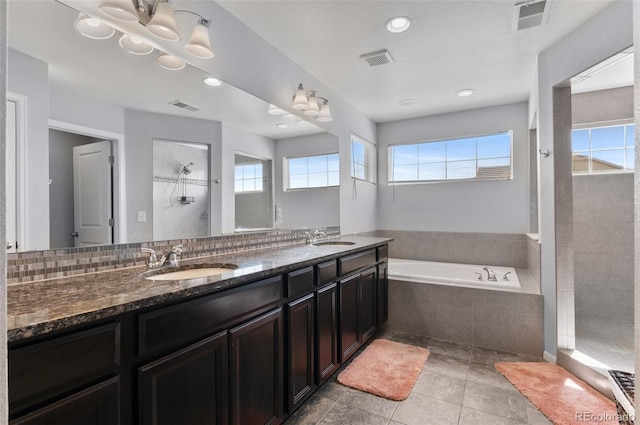23593 E Chenango Pl, Aurora, CO 80016 - bathroom featuring a garden tub, double vanity, a tile shower, recessed lighting, and tile patterned flooring