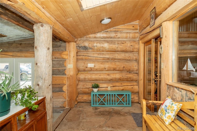 corridor featuring rustic walls, vaulted ceiling, wood ceiling, and stone finish flooring