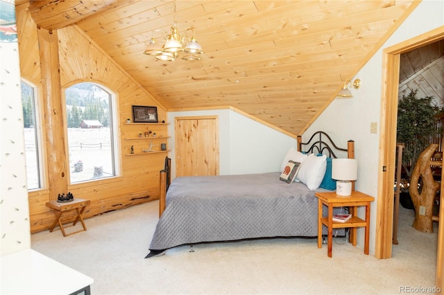 carpeted bedroom featuring vaulted ceiling, wooden ceiling, wooden walls, and a chandelier
