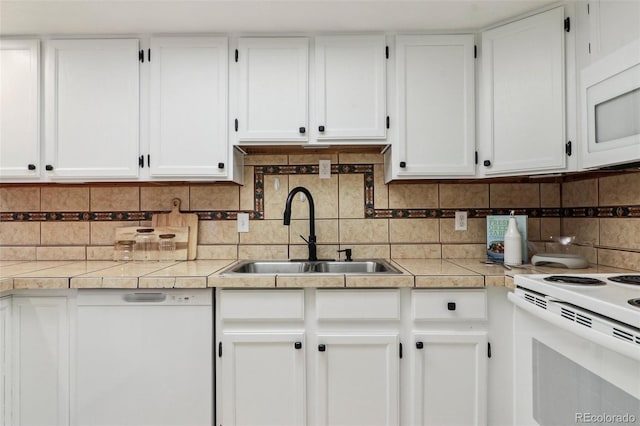 kitchen featuring white cabinetry, sink, white appliances, and decorative backsplash