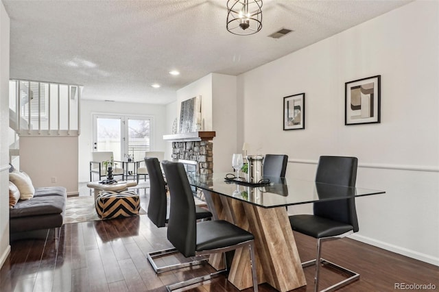 dining area featuring visible vents, baseboards, and wood finished floors
