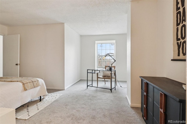 bedroom featuring carpet flooring, baseboards, and a textured ceiling
