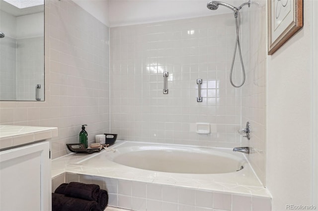 full bath featuring tiled shower / bath combo and vanity