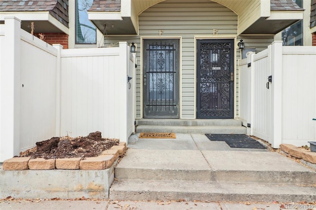 view of exterior entry featuring fence