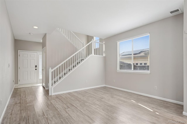 interior space featuring recessed lighting, visible vents, stairway, light wood-type flooring, and baseboards