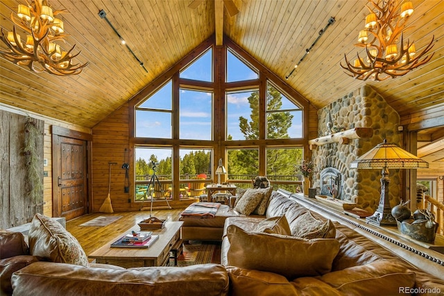 32806 Lakeside Dr, Buena Vista, CO 81211 - living room with a chandelier, a wooden ceiling with exposed beams, healthy amount of natural light, hardwood / wood-style flooring, and wooden walls