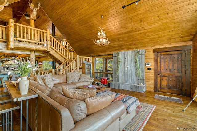 32806 Lakeside Dr, Buena Vista, CO 81211 - living room with high vaulted ceiling, stairs, wooden walls, a chandelier, and wooden ceiling