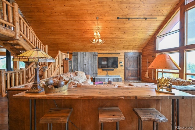 32806 Lakeside Dr, Buena Vista, CO 81211 - living area with wood ceiling, healthy amount of natural light, wood walls, high vaulted ceiling, and a chandelier