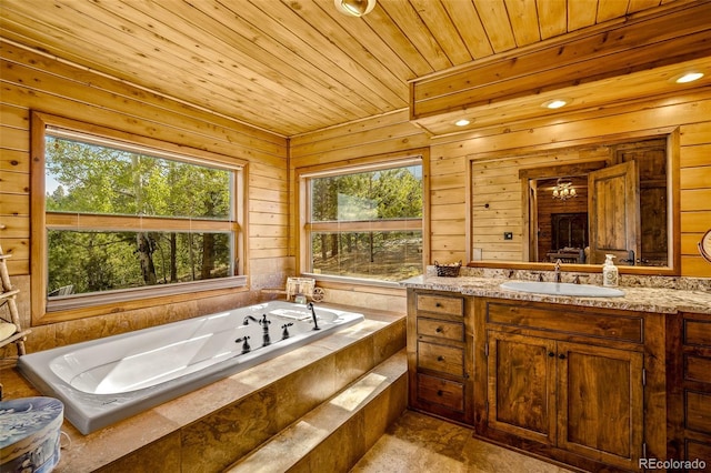 32806 Lakeside Dr, Buena Vista, CO 81211 - bathroom featuring healthy amount of natural light, vanity, a tub with jets, wooden ceiling, and wood walls