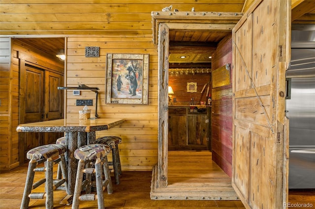 32806 Lakeside Dr, Buena Vista, CO 81211 - bar area with wooden walls, light wood-style floors, and wood ceiling