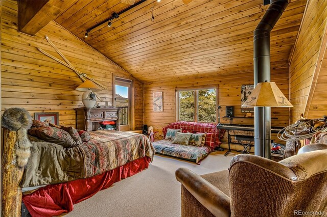 32806 Lakeside Dr, Buena Vista, CO 81211 - bedroom featuring track lighting, wooden ceiling, carpet flooring, wood walls, and vaulted ceiling