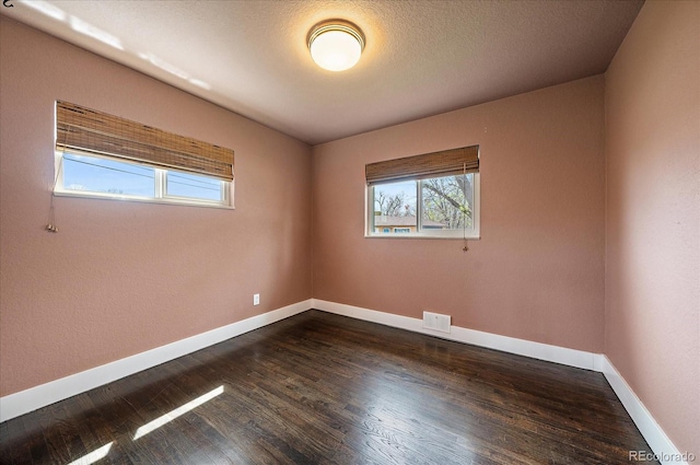 6026 Iris Way, Arvada, CO 80004 - unfurnished room with baseboards, dark wood-style flooring, and visible vents