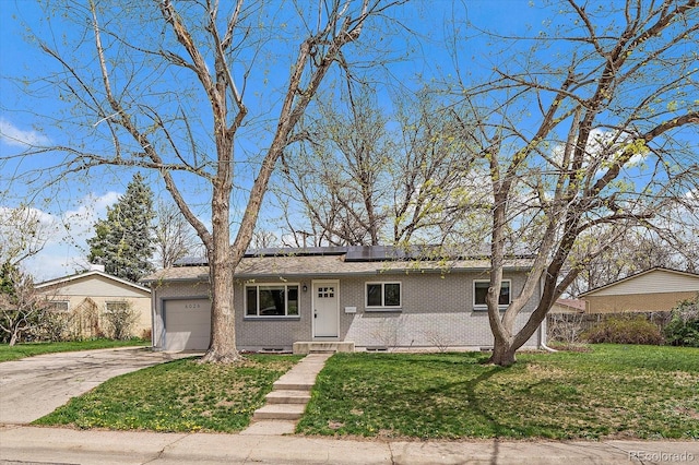 6026 Iris Way, Arvada, CO 80004 - ranch-style home with a front lawn, brick siding, driveway, and a garage