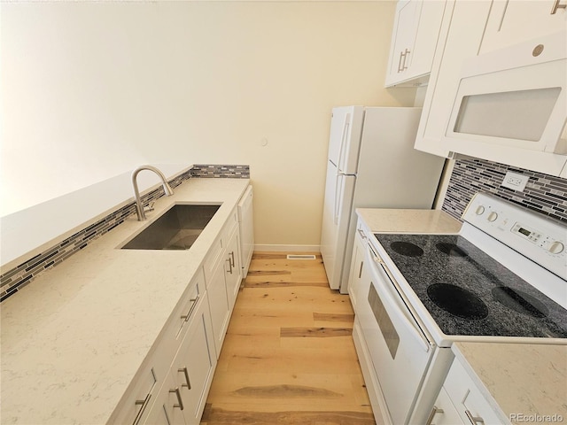 kitchen featuring light hardwood / wood-style flooring, sink, white cabinetry, white range with electric stovetop, and light stone counters