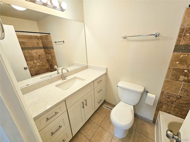 full bathroom with tiled shower / bath combo, vanity, toilet, and tile patterned floors