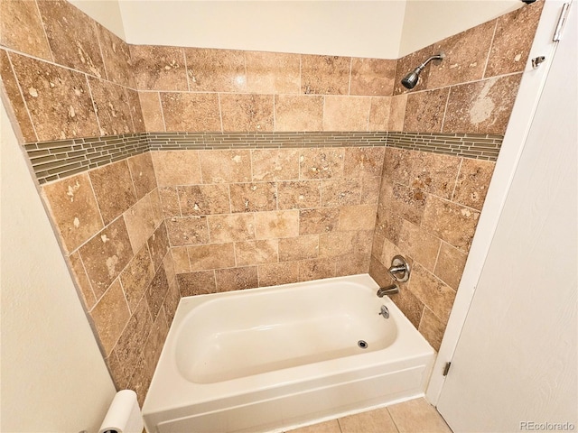 bathroom featuring tiled shower / bath and tile patterned flooring