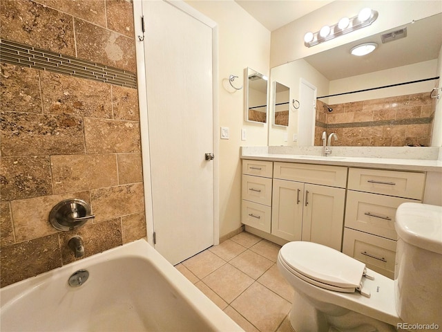 full bathroom featuring tile patterned flooring, tiled shower / bath, toilet, and vanity