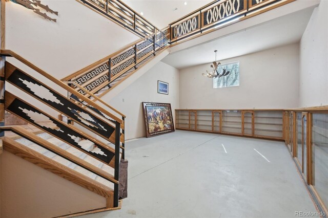 1055 N 18th St, Colorado Springs, CO 80904 - stairs featuring concrete flooring and a chandelier