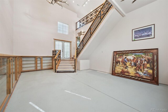 1055 N 18th St, Colorado Springs, CO 80904 - bonus room with stairs, a towering ceiling, and concrete floors