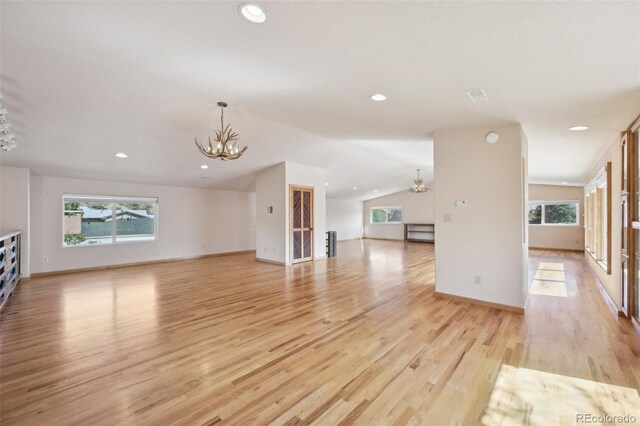 1055 N 18th St, Colorado Springs, CO 80904 - unfurnished living room with an inviting chandelier, light wood-style flooring, and plenty of natural light