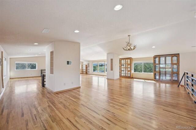1055 N 18th St, Colorado Springs, CO 80904 - unfurnished living room with recessed lighting, a wealth of natural light, and light wood-style floors