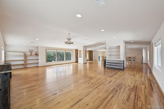 1055 N 18th St, Colorado Springs, CO 80904 - unfurnished living room featuring light wood-style floors, visible vents, baseboards, an inviting chandelier, and recessed lighting