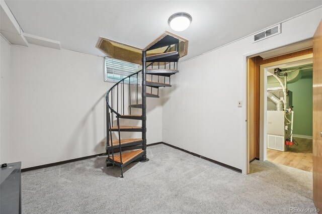 1055 N 18th St, Colorado Springs, CO 80904 - stairway featuring visible vents, heating unit, carpet, and baseboards